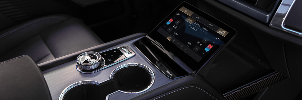 Close-up of the 2027 Cadillac VISTIQ Middle Console Including the Cup Holders, Gear Knob and Climate Control Screen